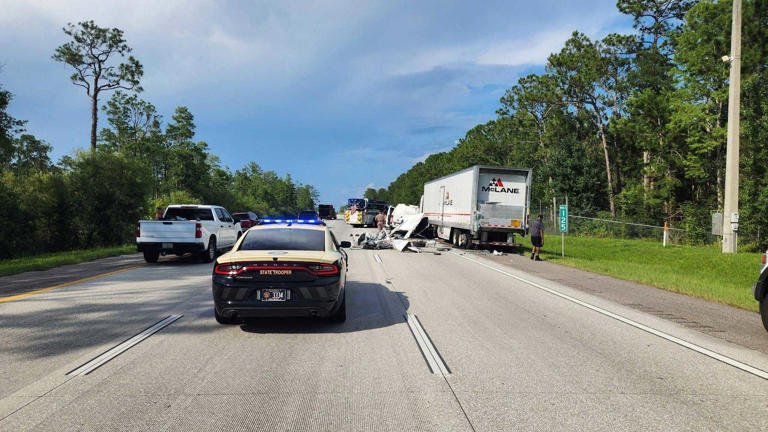 Photos: Van splits in half after crashing into parked semi-trailer on I ...