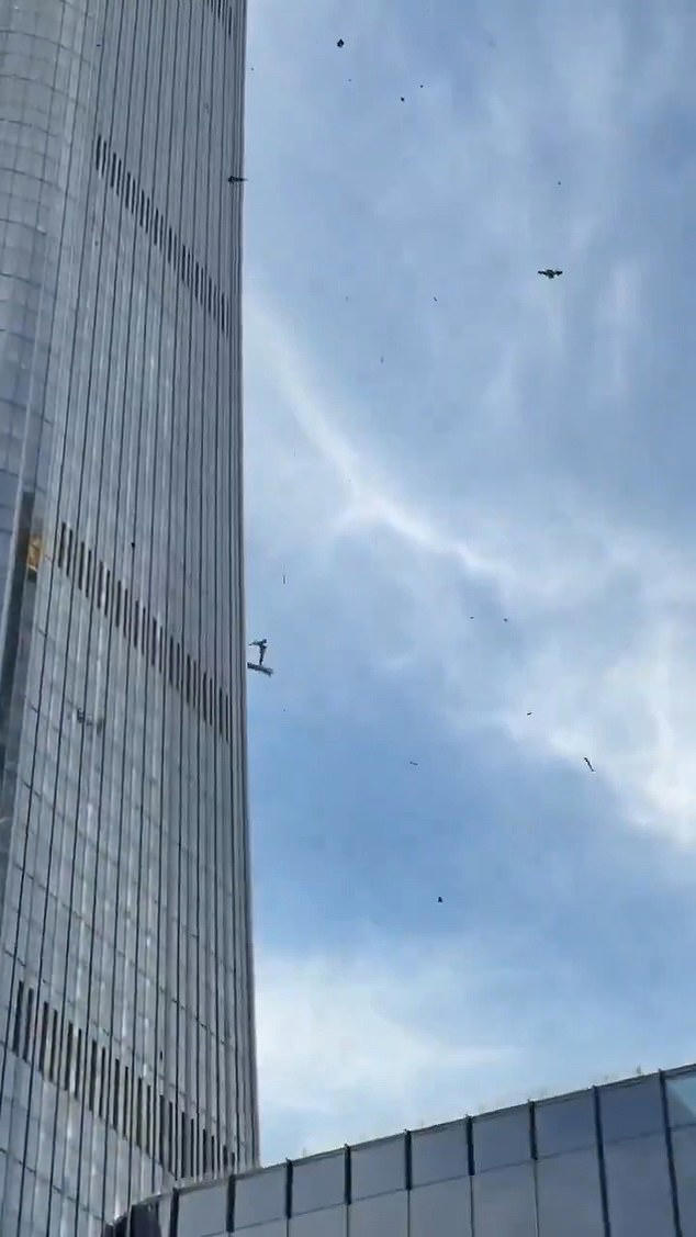 Dramatic footage circulating on social media showed debris falling from the 109-story tower, as well as a tail section of the plane and a broken window of a taxicab on the ground
