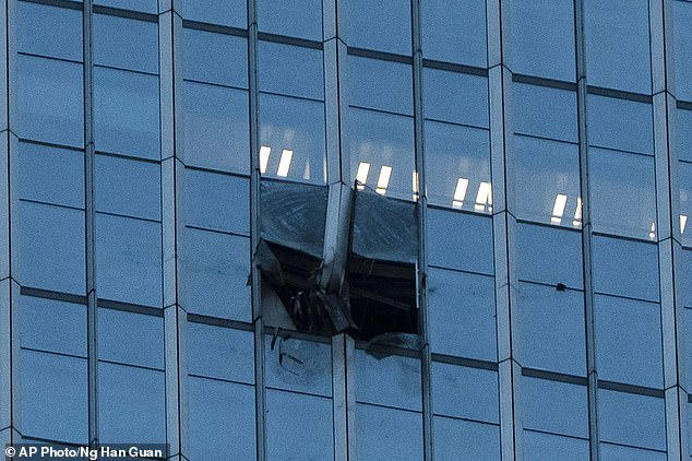 Photographs show two smashed windows in the side of the building, which is located in the capital’s busy central business district, Chaoyang District 