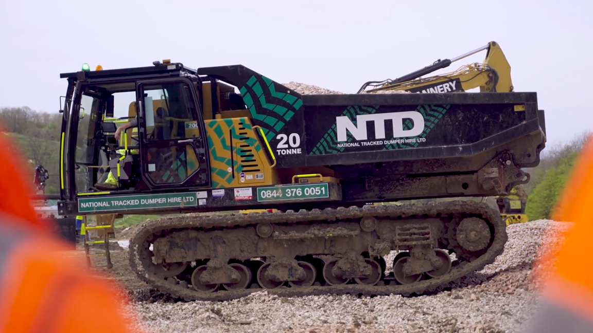 Massive tracked dump carrier moving tons of material with ease
