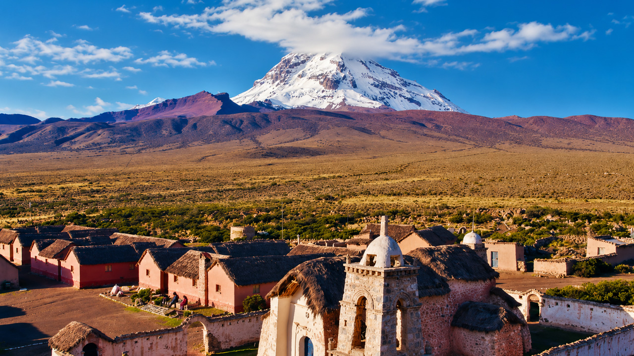 A quiet village living beneath a giant snow covered volcano