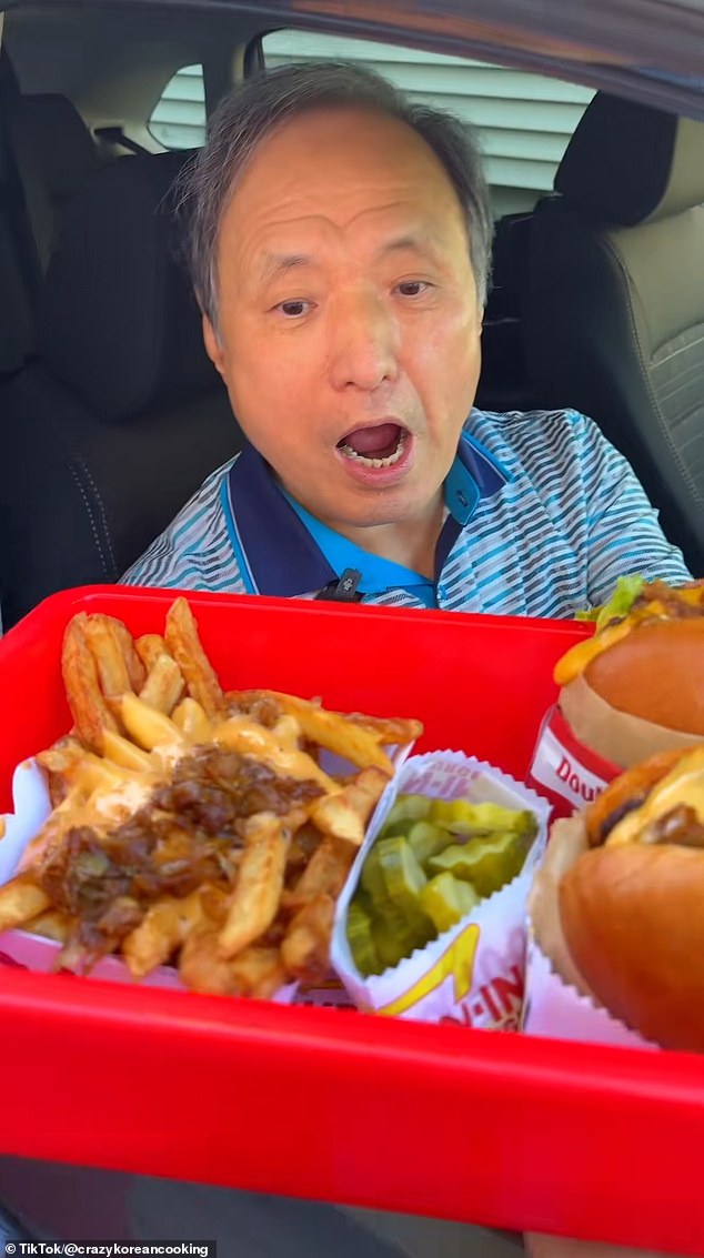 Lewis' father is pictured placing his order at the drive-thru window of their home in New Jersey
