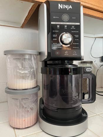Ninja ice cream maker with black and silver design, two ice cream tubs labeled