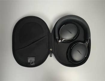 Wireless headphones in a protective case, displayed open to show compact design, suitable for travel or everyday use
