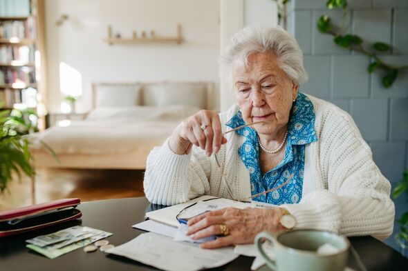 Senior woman has financial problems. Counting money, monthly pension, don't have enough money for paying bills.