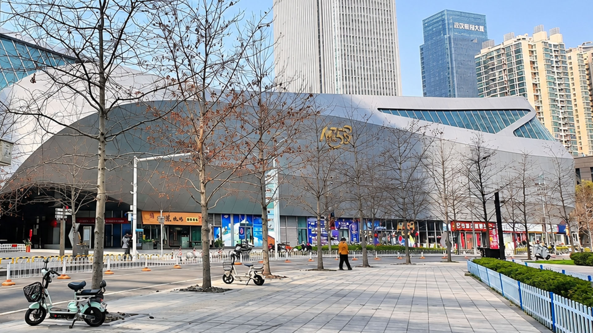 Inside a quiet city plaza where sharp architecture meets tall towers