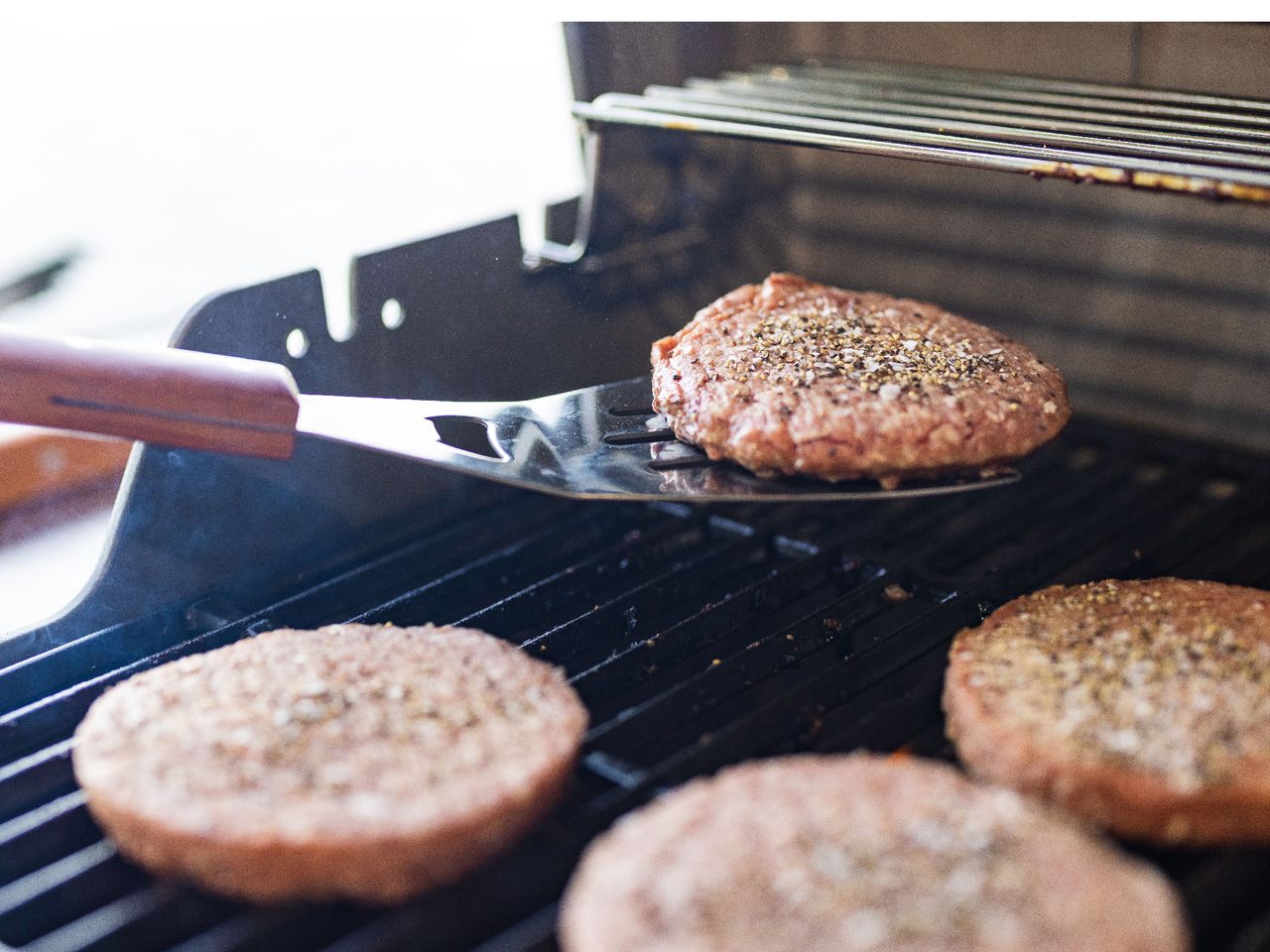 beef burger patties on grill