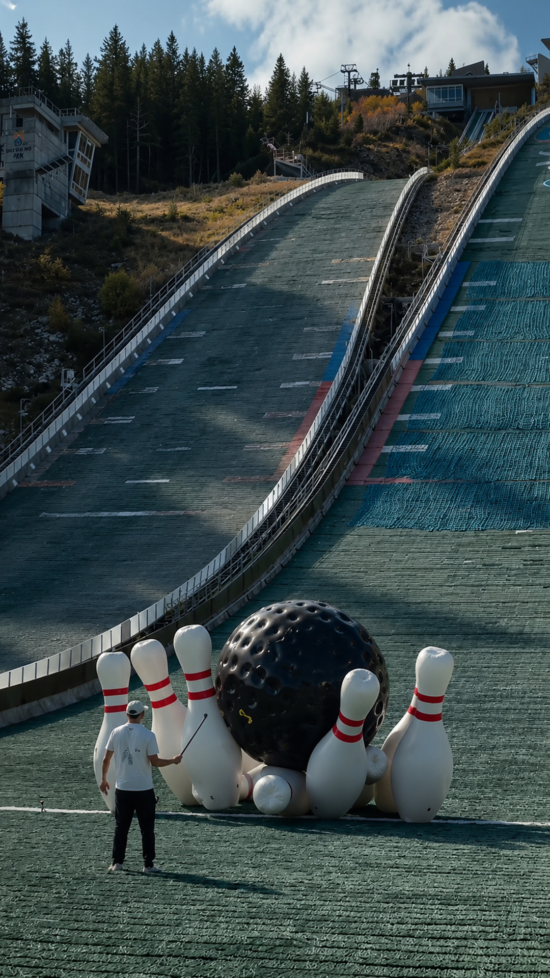 Rolling a huge bowling ball down a high ski jump