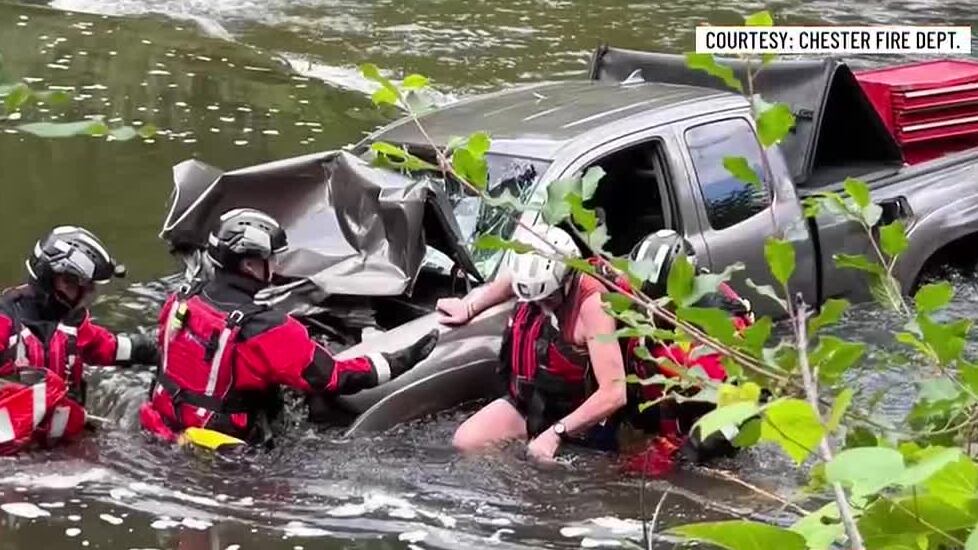 Crews rescue driver after pickup crashes into river