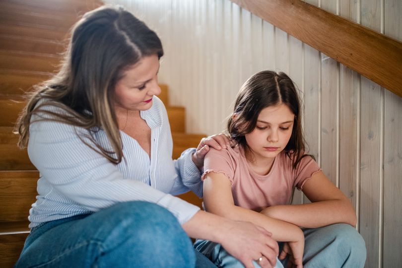 Mother helping her teenage daughter cope with emotional problems.
