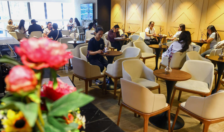 Overseas Filipino workers relax at the Philippine Consulate's newly opened OFW Centre at United Centre in Hong Kong on May 27. Photo: Dickson Lee
