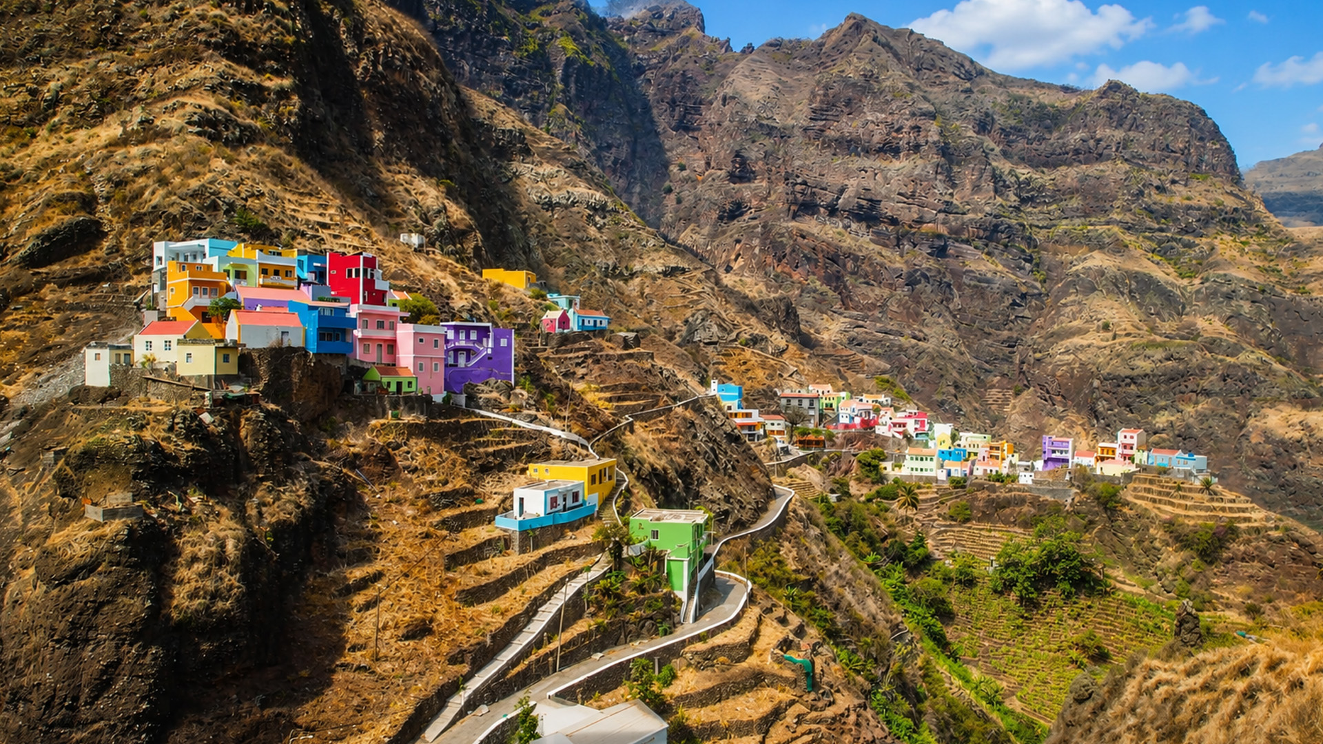 A colorful village hidden among volcanic mountains