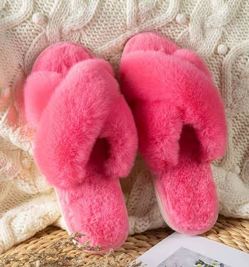 the pink slippers on a knit blanket