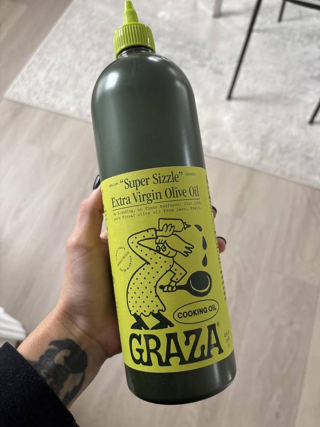 Person holding a bottle of Graza