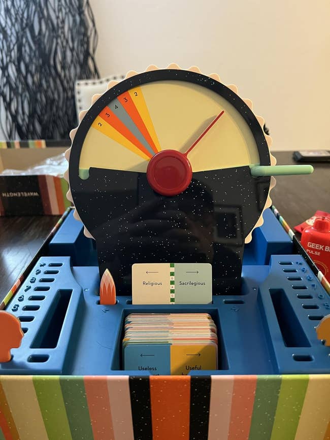 Board game with a spinner and cards featuring categories like