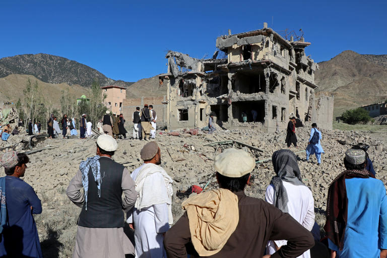 Afghan residents look at the remains of a building damaged in a Pakistani airstrike at a village in Tsamkani district of Afghanistan's Paktia province (AFP/Getty)
