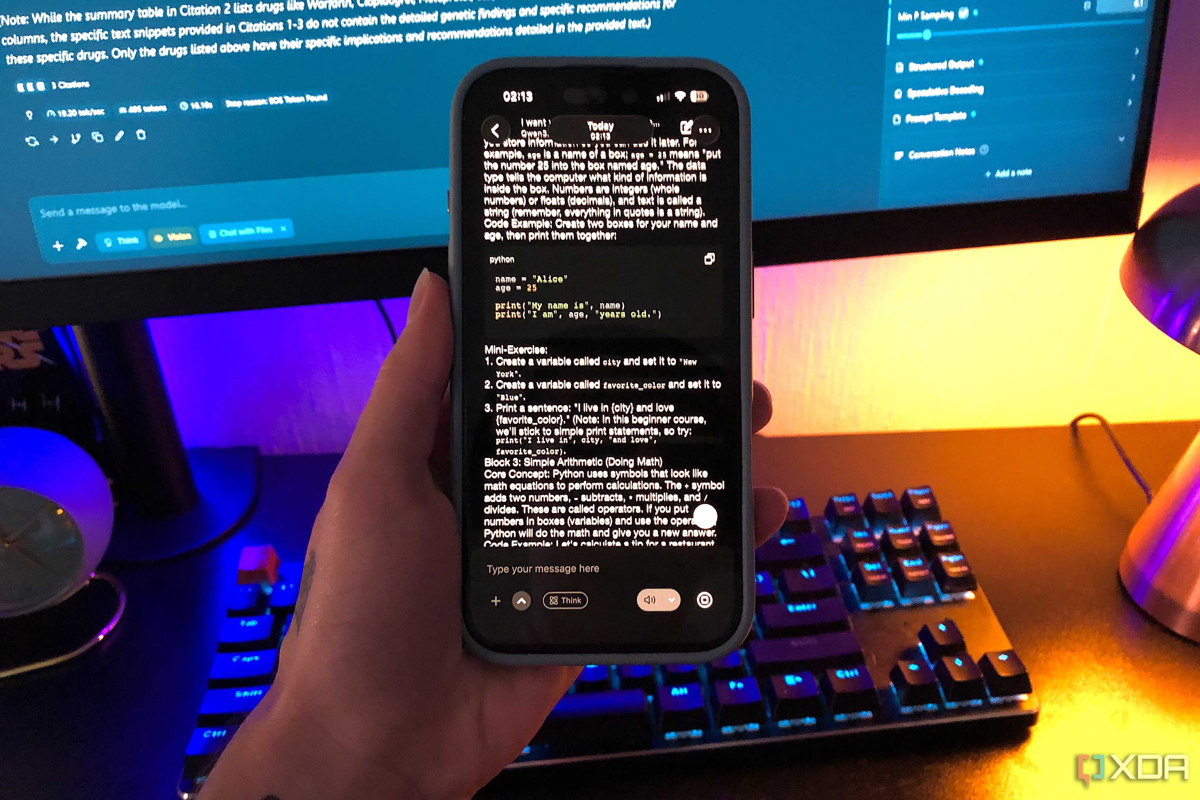 qwen 3.5 on iphone, desktop monitor and keyboard in background