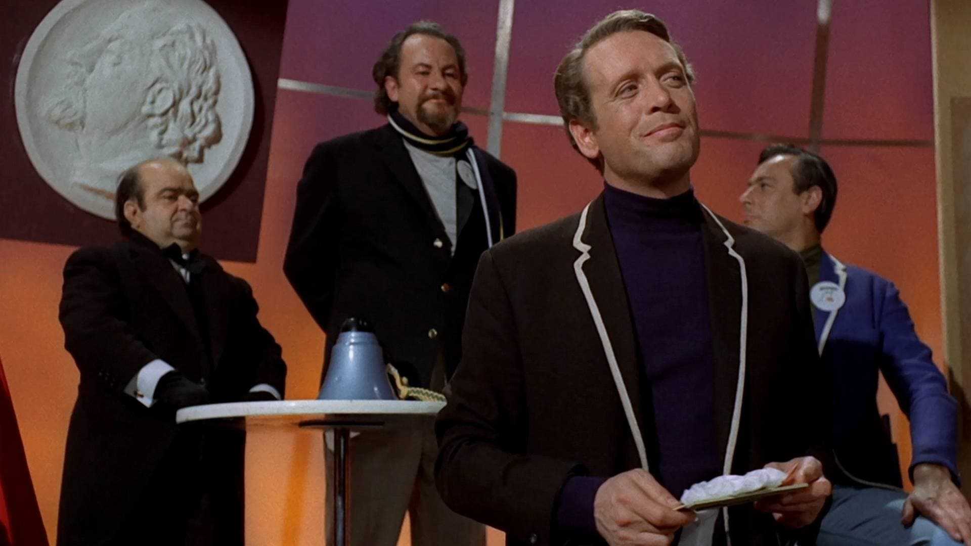 The Prisoner shows Number Six with men sitting behind him