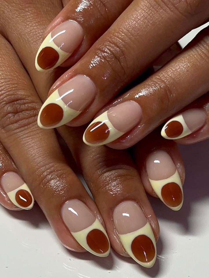 Closeup of hands showing nails with an artistic design featuring rounded patterns