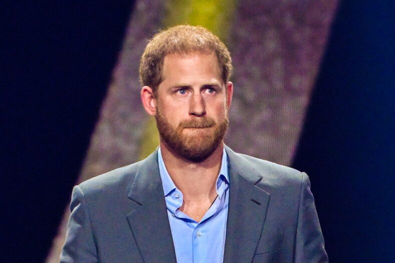 Prince Harry looks on from stage