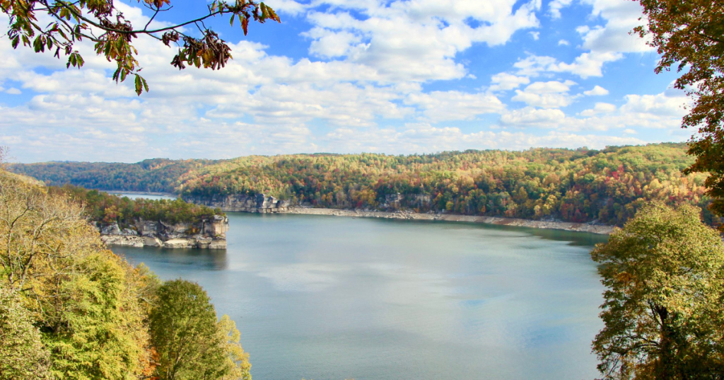 Breathtaking Summersville Lake, a blue lake in WV, surrounded by dense forests in early autumn.