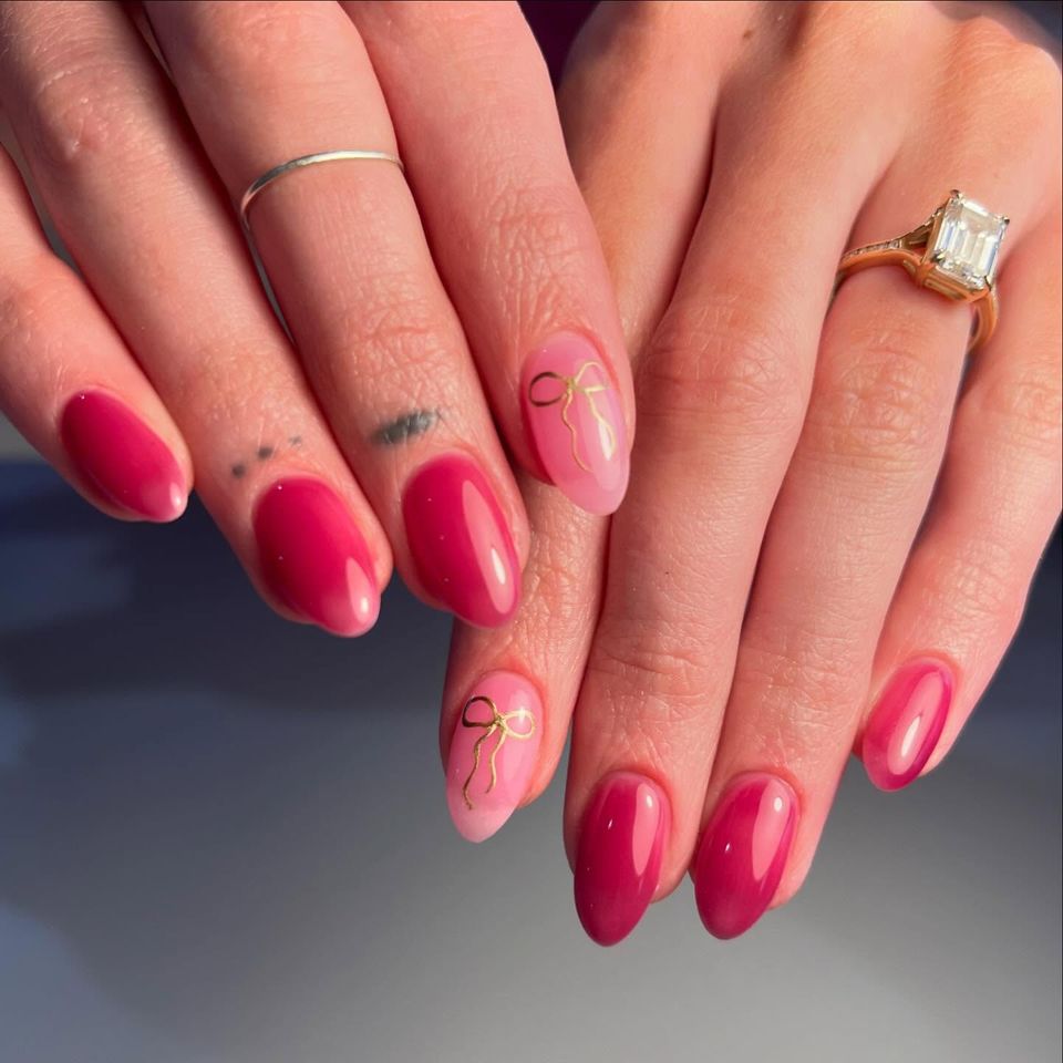 Hands with manicured nails one hand wearing a ring with a large gem