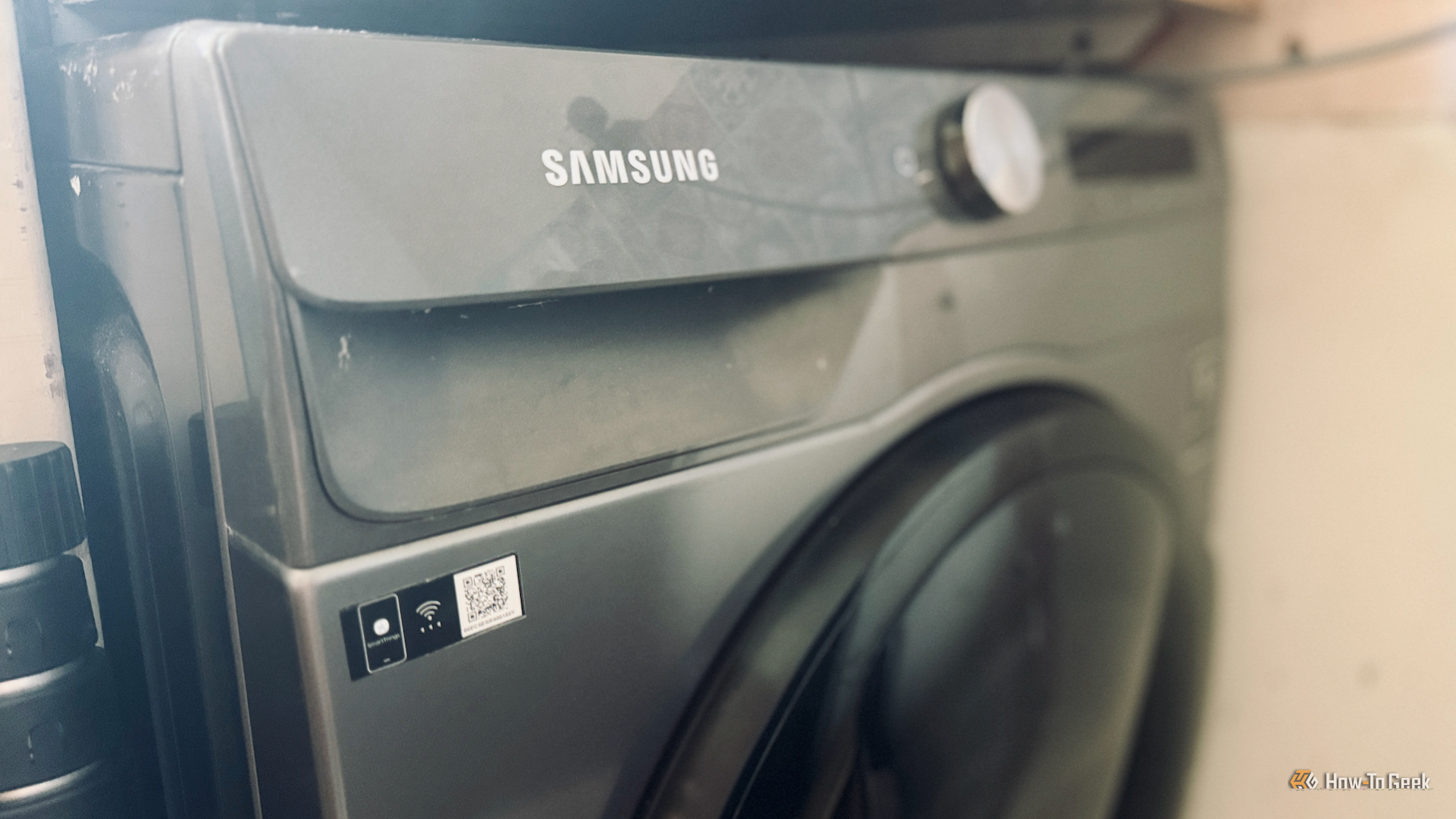A Samsung washing machine with a Wi-Fi label on the front of it.