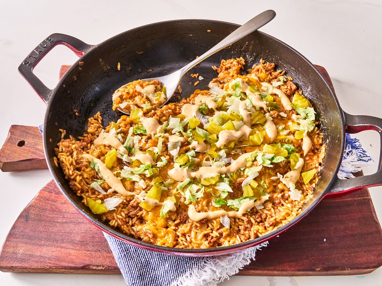 skillet cheeseburger rice on board with blue napkin