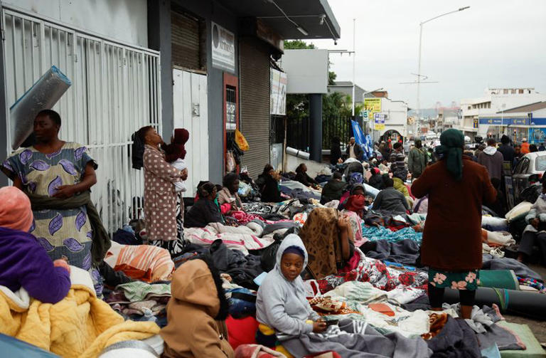 Foreign nationals sleep on the street, in front of a Home Affairs office in Durban, South Africa, June 30, 2026. REUTERS/Rogan Ward