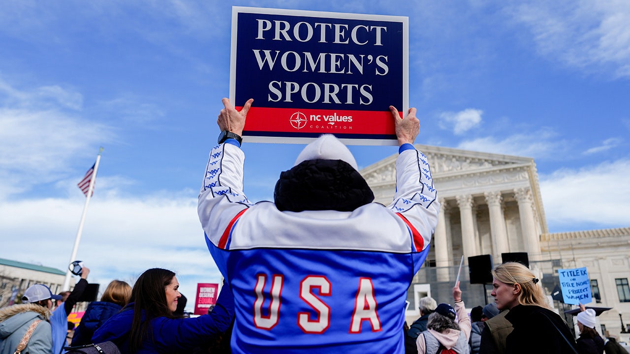 A protester holding a sign outside the Supreme Court building in Washington, D.C.
