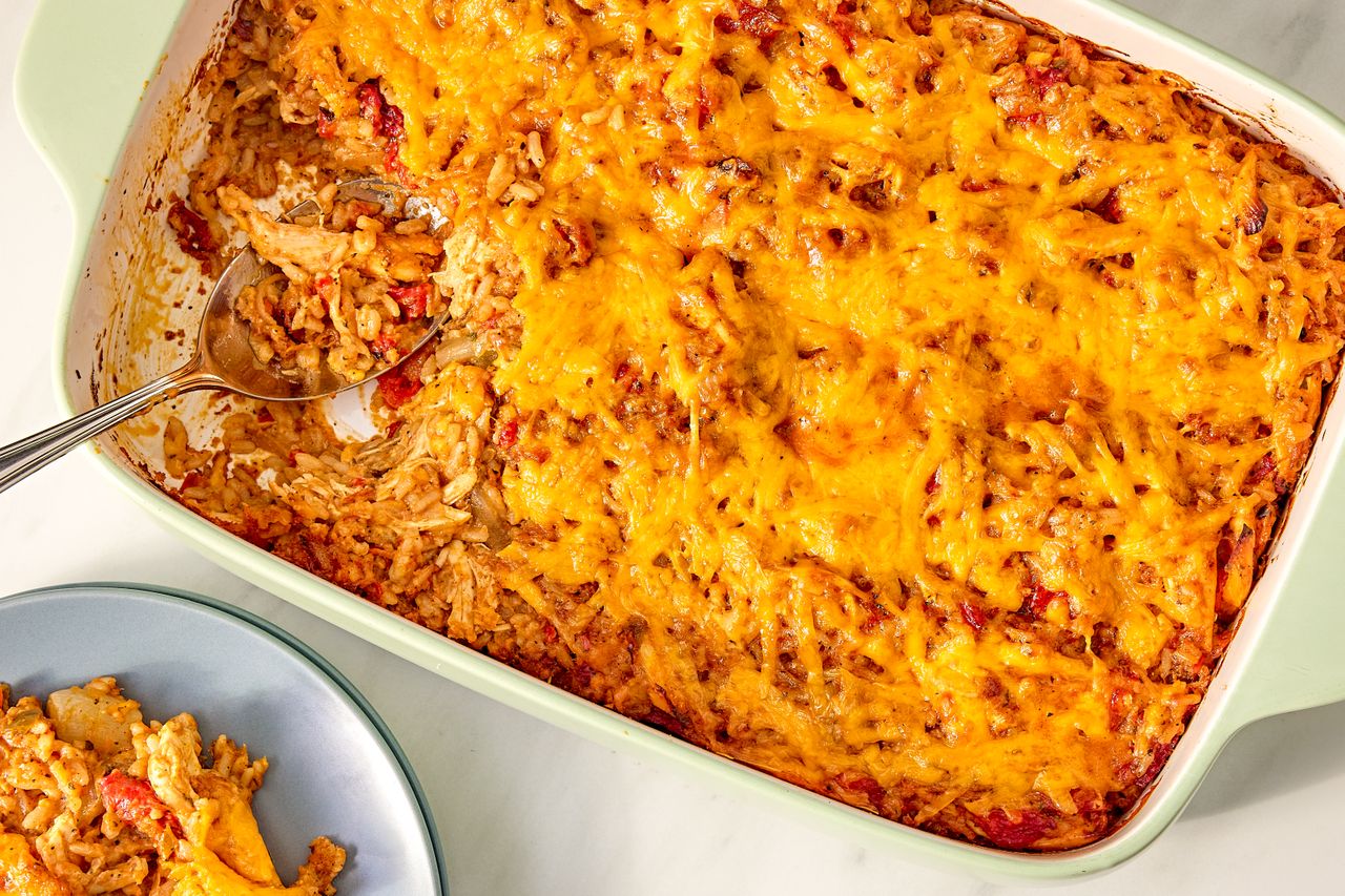 Baked casserole dish with a serving spoon and a plate of the dish served on the side