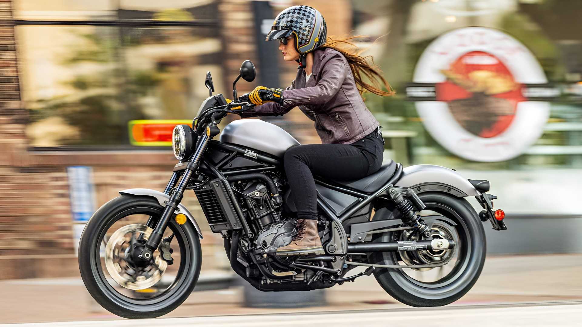 2026 Honda Rebel 1100 accelerating through city roads front third quarter profile view