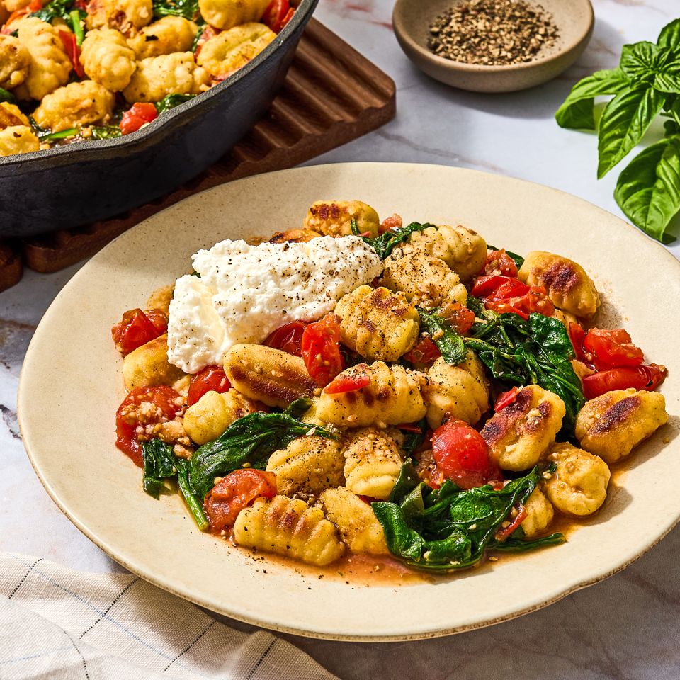 Skillet gnocchi with tomatoes spinach and ricotta cheese on a plate