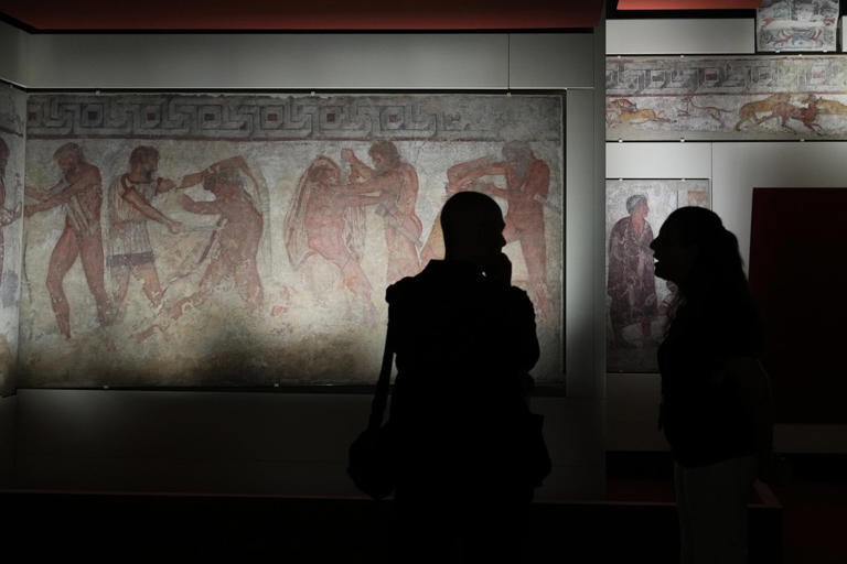 Italy displays paintings from an ancient Etruscan tomb, its latest ...