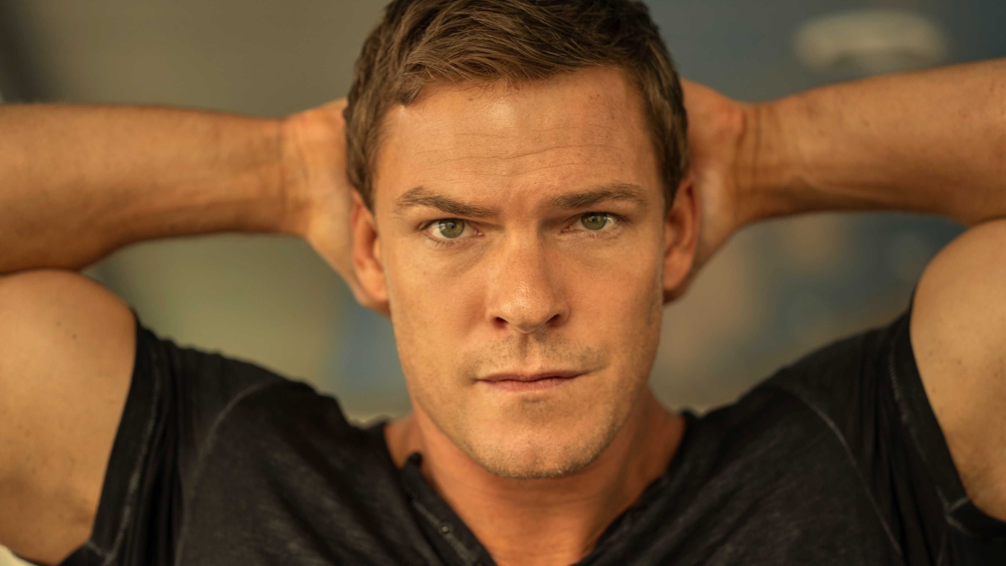 Alan Ritchson’s Jack Reacher with his hands behind his head in Prime Video’s Reacher