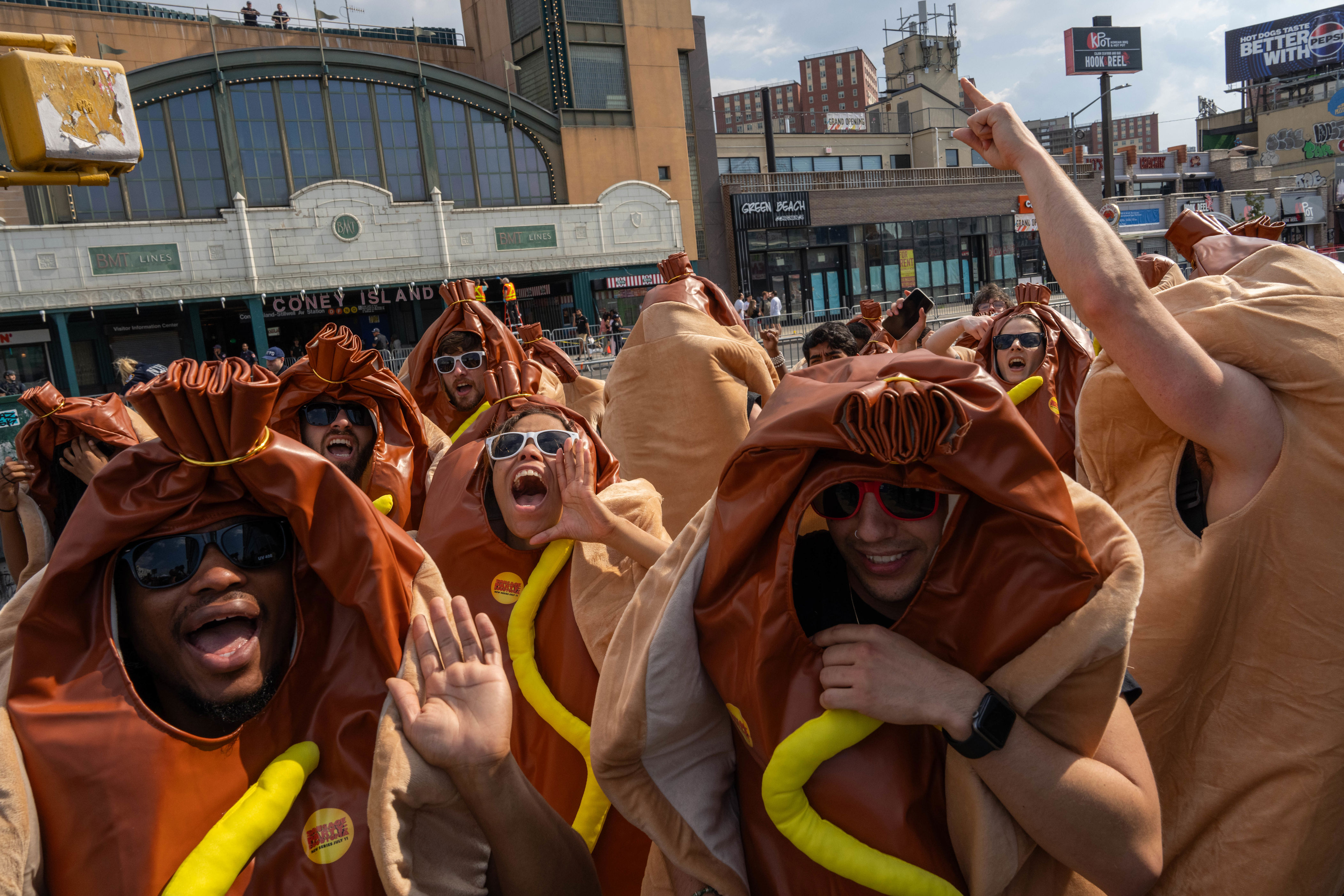 People dressed in hot dog costumes cheer before Nathan's Annual Hot Dog Eating Contest on July 4, 2024 in Brooklyn.
