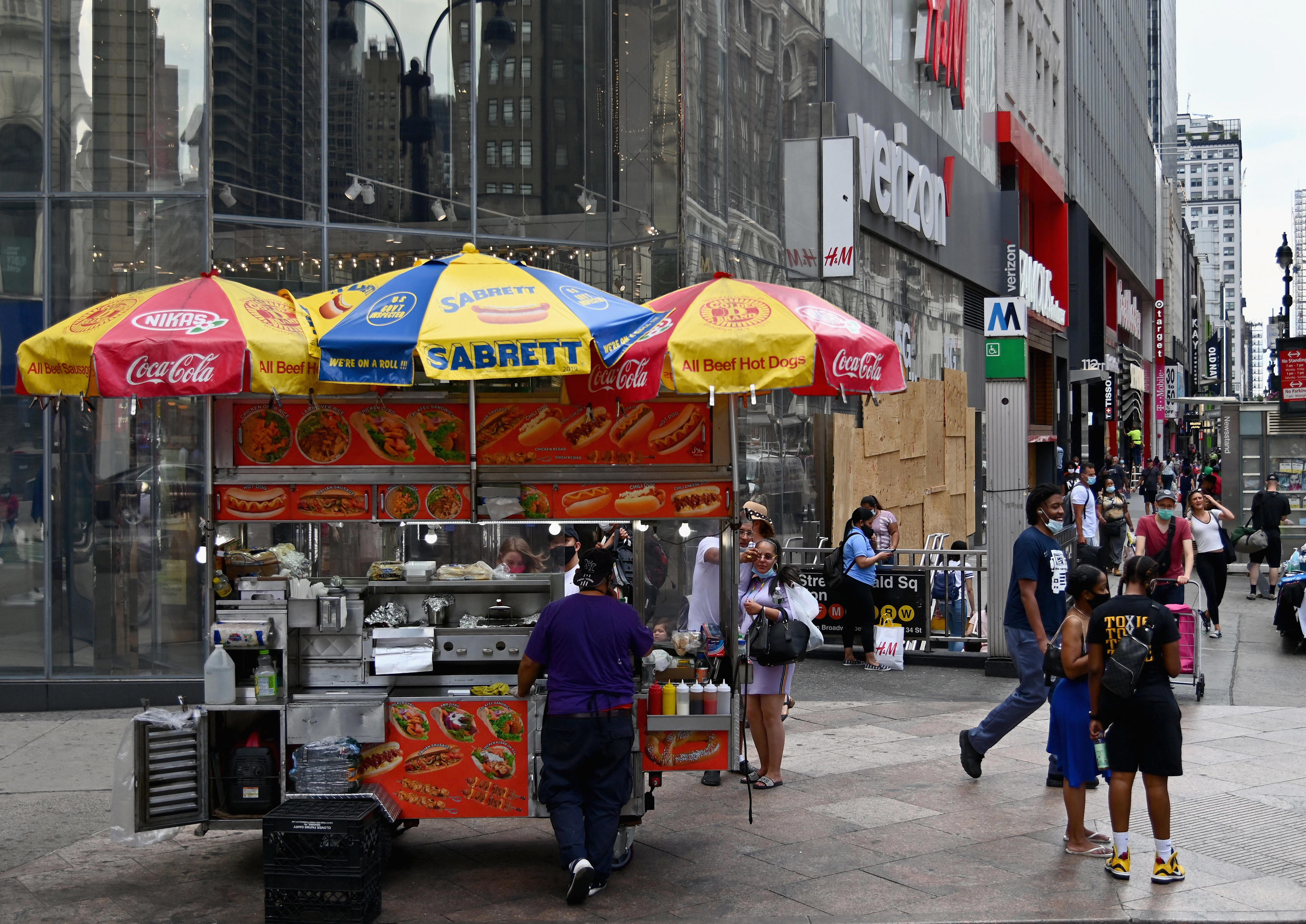 People wait to be served a a hot dog stand near Herald Square on June 25, 2020 in New York City.