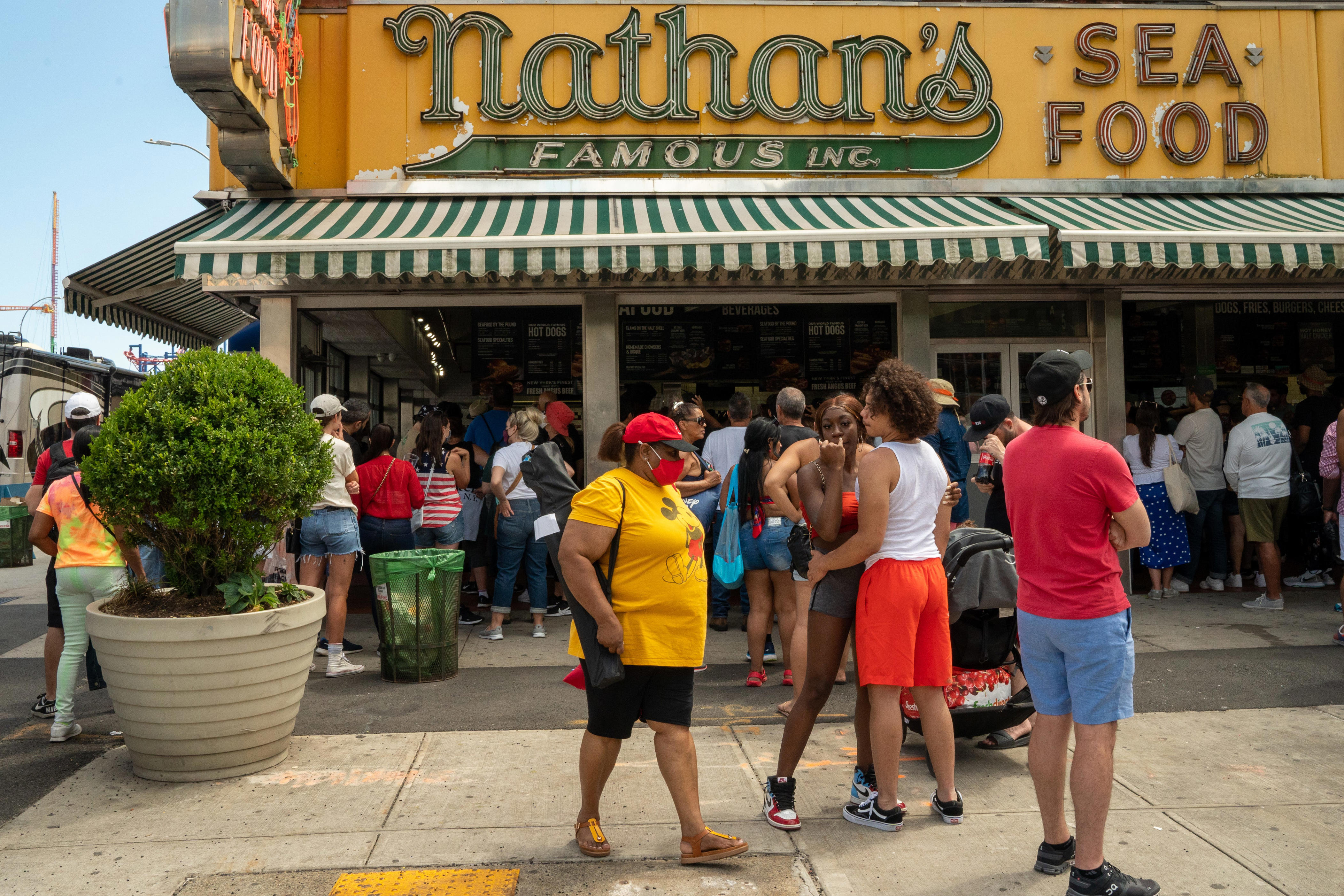 People wait for a Nathan's Famous hot dog at Coney Island beach on July 4, 2021 in New York City.