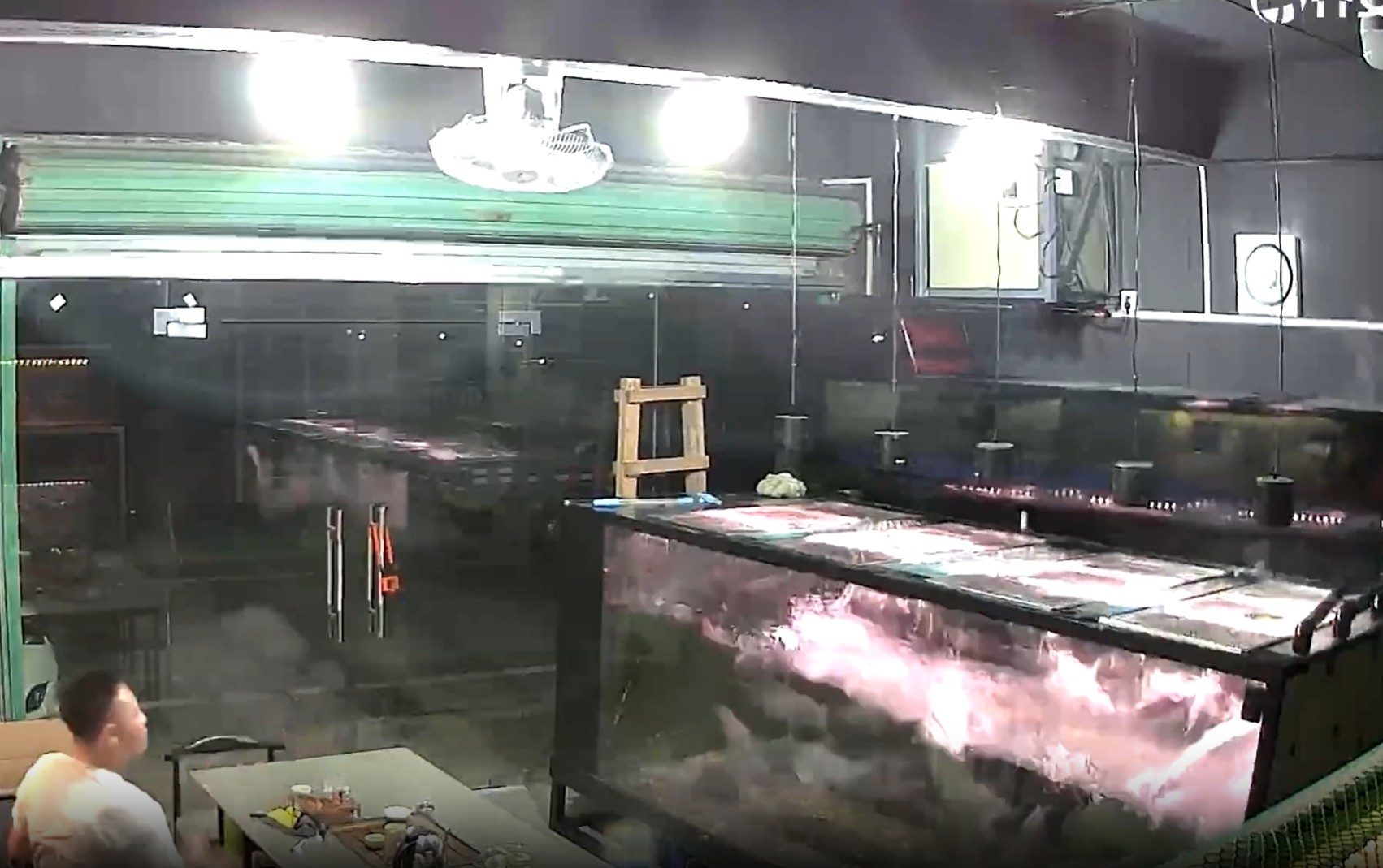 CCTV captures fish tank exploding as owner stays remarkably calm