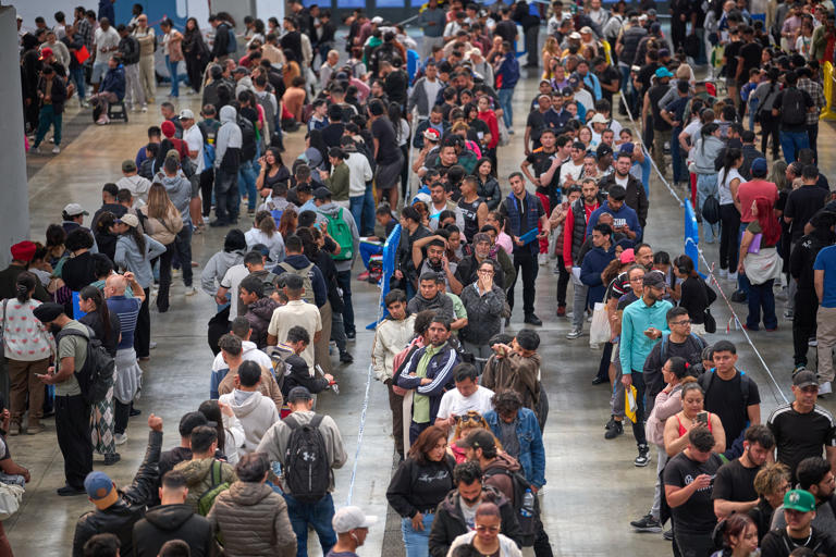On April, migrants line up at a government office in Barcelona, Spain, to receive documents required to apply for the country's immigration legalization system. /AP-Yonhap