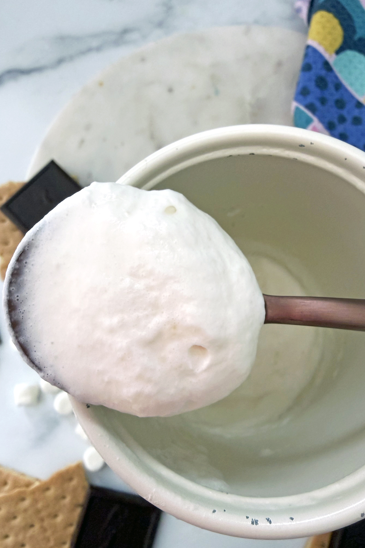 Marshmallow cold foam on a spoon.