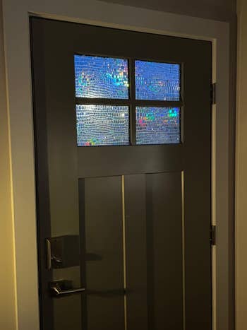 Window privacy film with a mosaic pattern decorates a door's upper glass panels, adding privacy while allowing light to enter