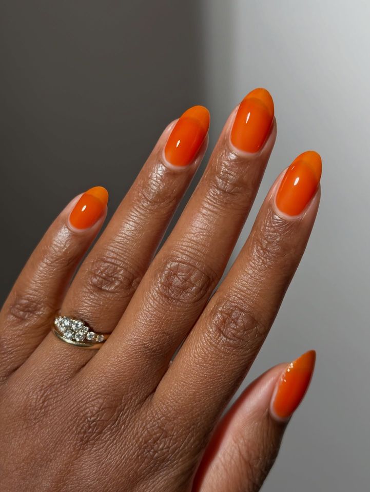 A hand with manicured nails and a ring on a finger