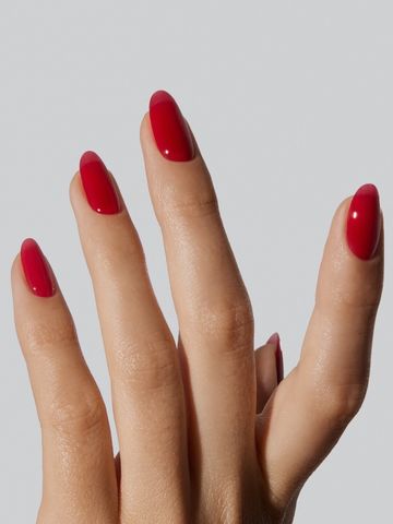 Hand with fingernails painted red shown in an elegant pose