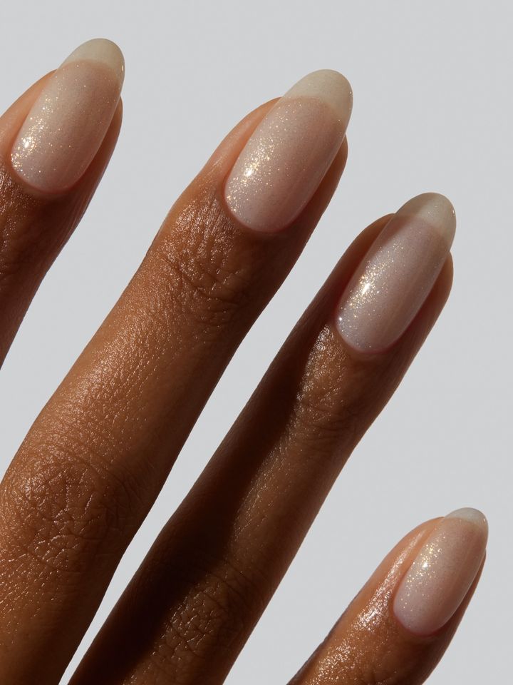 A hand with neatly manicured nails shown closeup