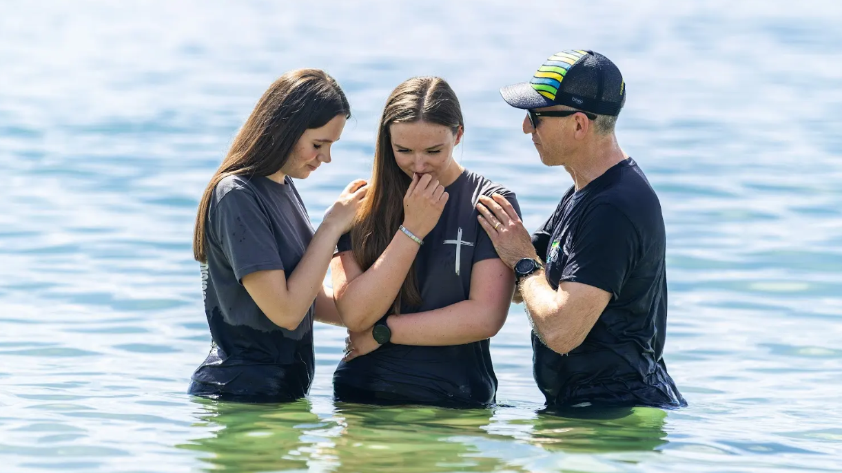 Hundreds gather on beach for mass baptisms in sea
