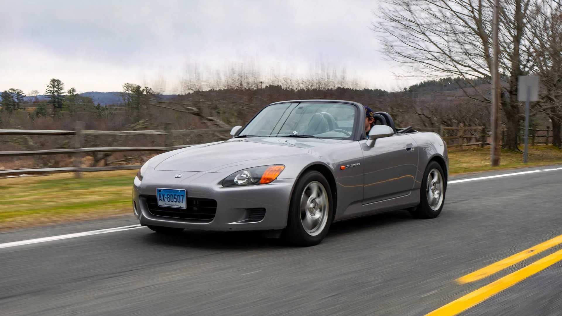 Front 3/4 action shot of 2000 Honda S2000 driving on road