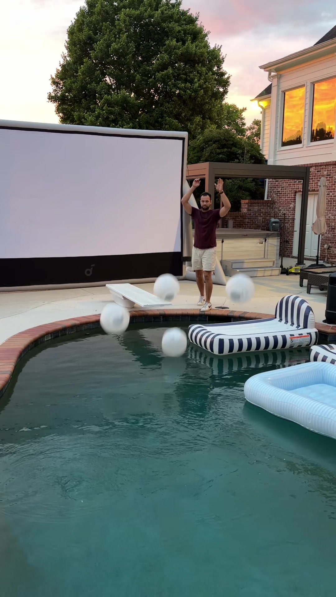 Outdoor movie night with a poolside projector setup