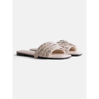 Stylish flat sandals with layered circular embellishments on the strap, ideal for casual wear