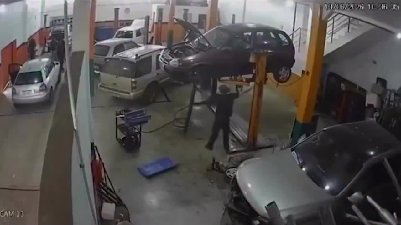 Car falls from workshop lift and narrowly missing mechanic